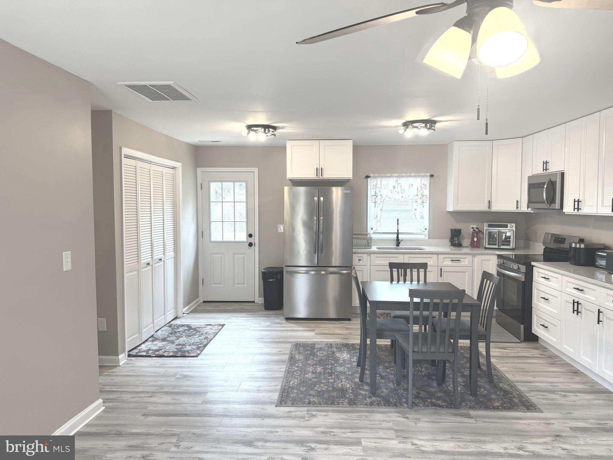 32201 Johnson Road Salisbury, MD 21804 - Photo 4 of 50 a kitchen with stainless steel appliances granite countertop a stove refrigerator and cabinets