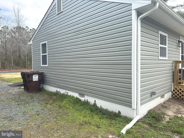 a view of a small house and a yard