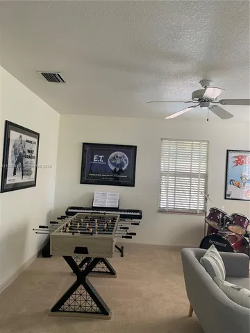 a living room with furniture a flat screen tv and a window