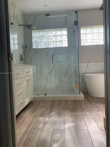 a bathroom with a bathtub and a shower