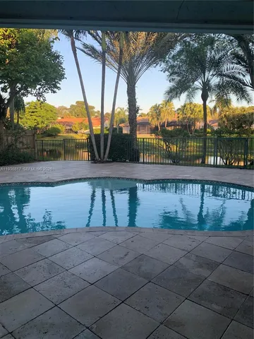 a view of swimming pool with outdoor seating and yard