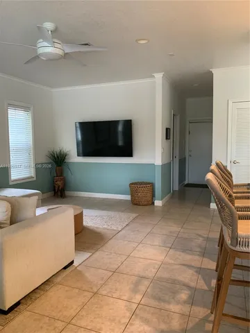 a dining room with furniture a chandelier and a rug