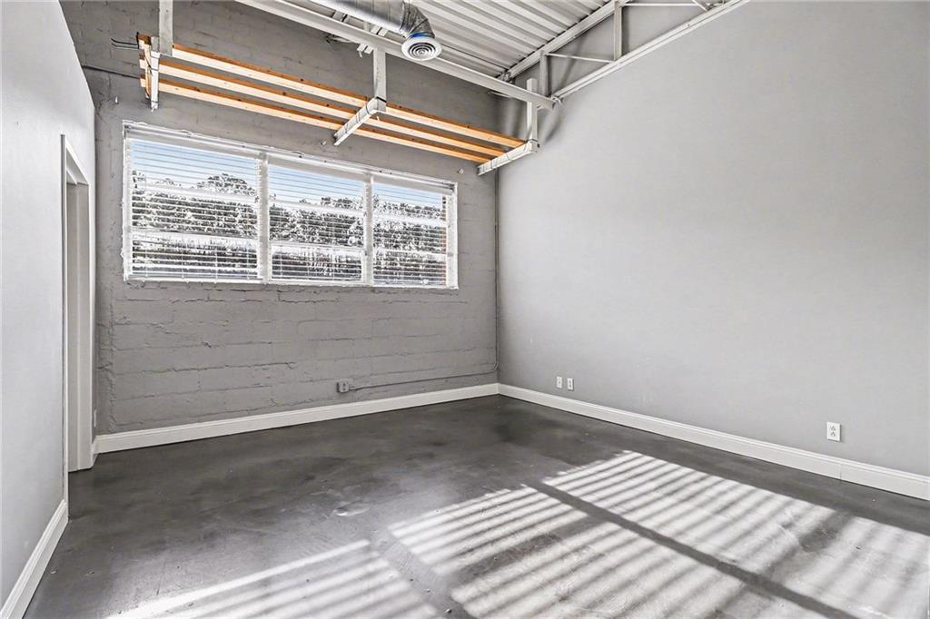 5200 Peachtree Road, Unit 2101 Atlanta, GA 30341 - Photo 15 of 37 a view of a small space with wooden floor and a window