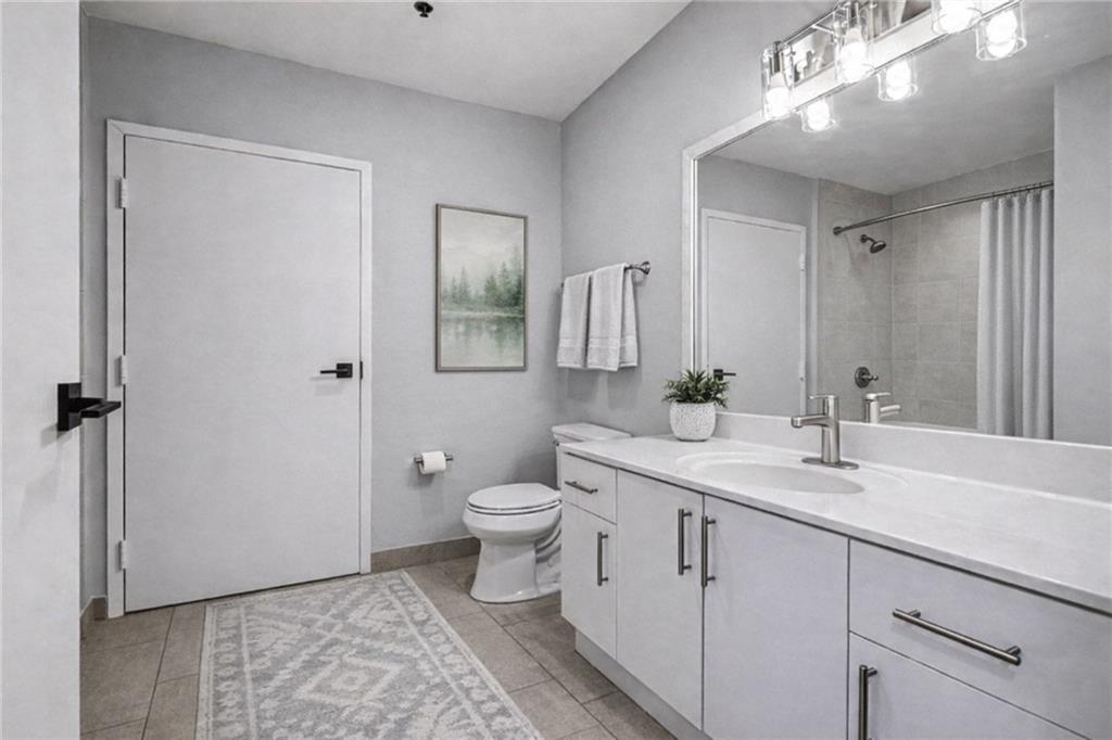 5200 Peachtree Road, Unit 2101 Atlanta, GA 30341 - Photo 18 of 37 a spacious bathroom with a toilet sink and mirror