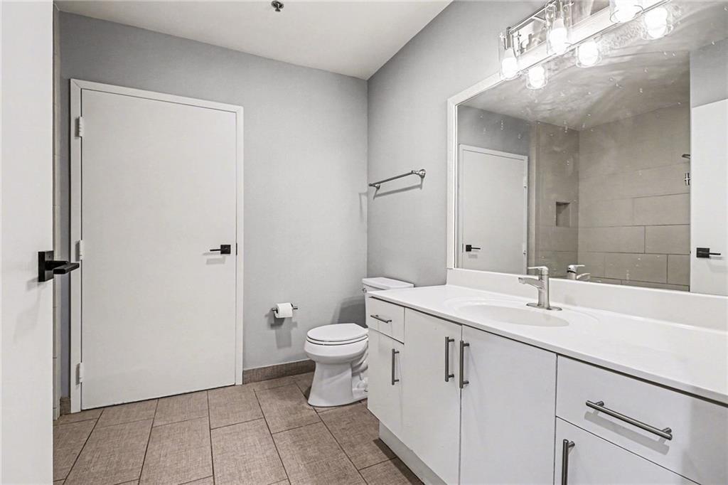 5200 Peachtree Road, Unit 2101 Atlanta, GA 30341 - Photo 19 of 37 a bathroom with a toilet sink and mirror