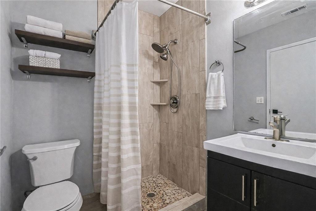 5200 Peachtree Road, Unit 2101 Atlanta, GA 30341 - Photo 22 of 37 a bathroom with a sink a toilet and shower