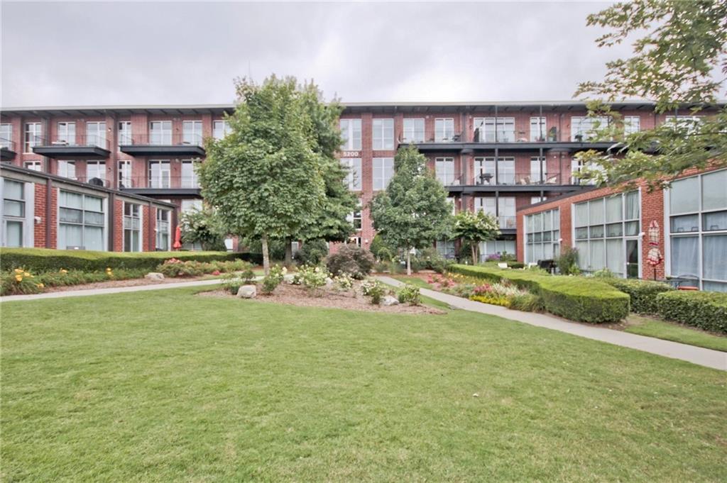 5200 Peachtree Road, Unit 2101 Atlanta, GA 30341 - Photo 27 of 37 a view of a house with a patio and a yard