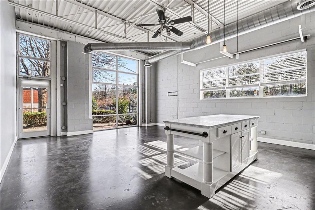 5200 Peachtree Road, Unit 2101 Atlanta, GA 30341 - Photo 5 of 37 a kitchen with stainless steel appliances a stove and wooden floor