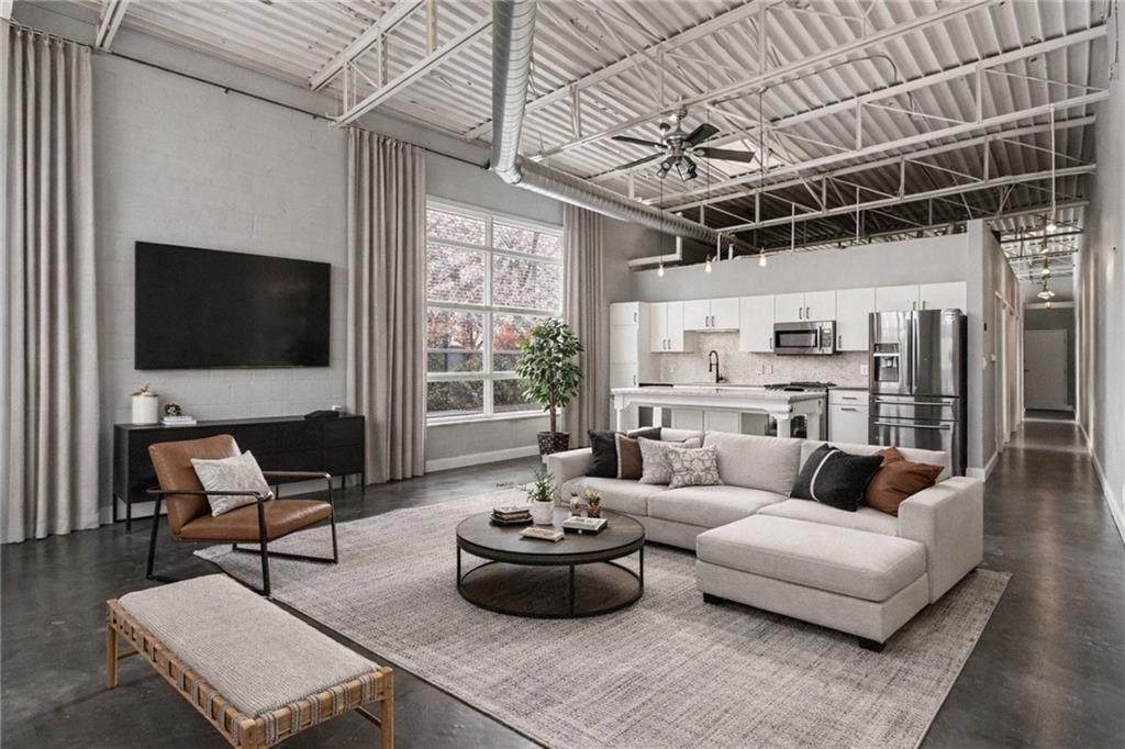 5200 Peachtree Road, Unit 2101 Atlanta, GA 30341 - Photo 8 of 37 a living room with furniture and a flat screen tv