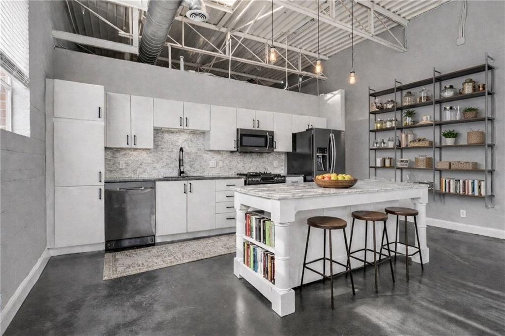 5200 Peachtree Road, Unit 2101 Atlanta, GA 30341 - Photo 10 of 37 a kitchen with stainless steel appliances granite countertop a stove and cabinets