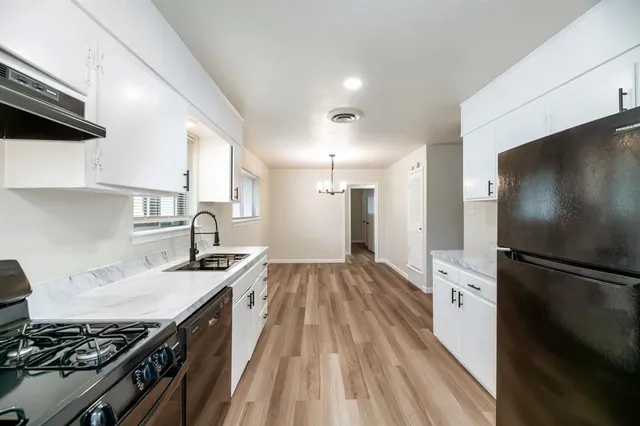a kitchen with a sink stove and refrigerator