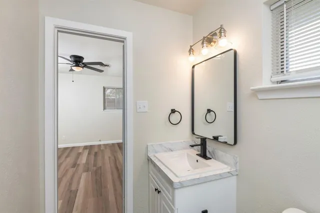 a bathroom with a sink a mirror and a shower