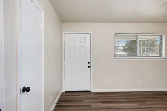 a view of an entryway with wooden floor