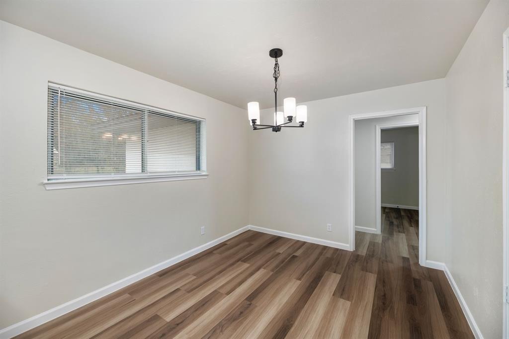 102 Mildred Lane Benbrook, TX 76126 - Photo 8 of 25 a view of empty room with wooden floor