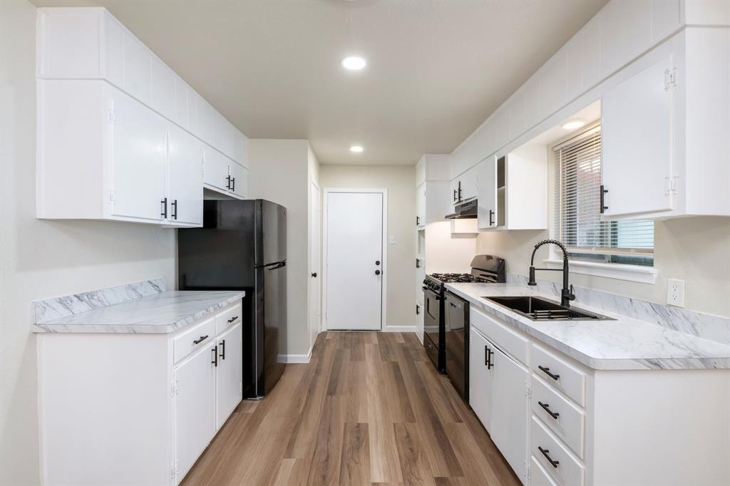 102 Mildred Lane Benbrook, TX 76126 - Photo 10 of 25 a kitchen with stainless steel appliances granite countertop a sink stove refrigerator and cabinets
