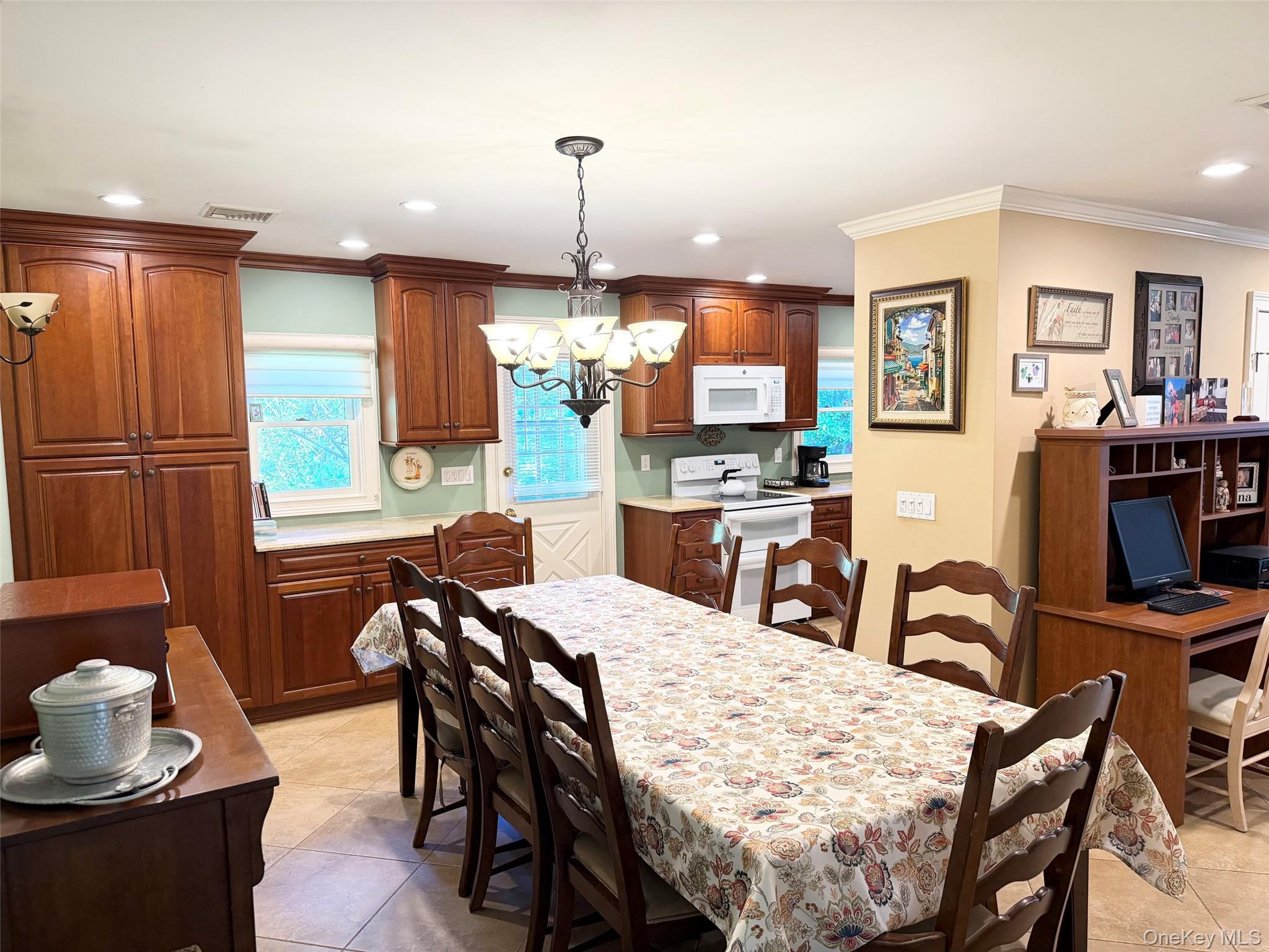 304 Dare Road Selden, NY 11784 - Photo 9 of 24 Kitchen featuring wood cabinetry, white appliances, recessed lighting, and a built-in desk area
