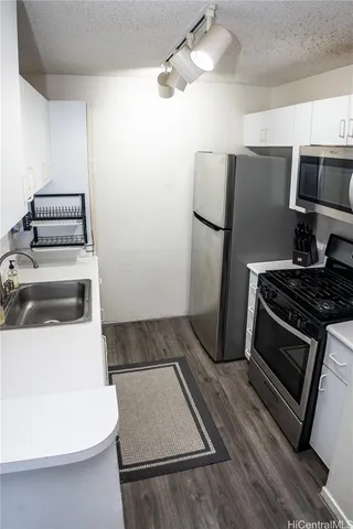 a kitchen with stainless steel appliances a stove a microwave and a refrigerator