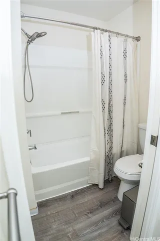 a bathroom with a shower a toilet and a shower