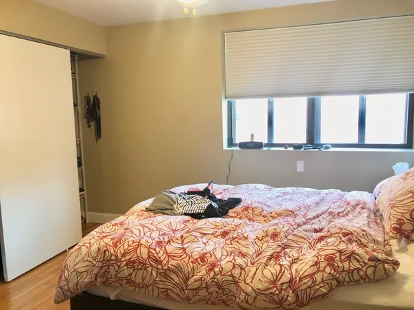 a bedroom with a bed and a window