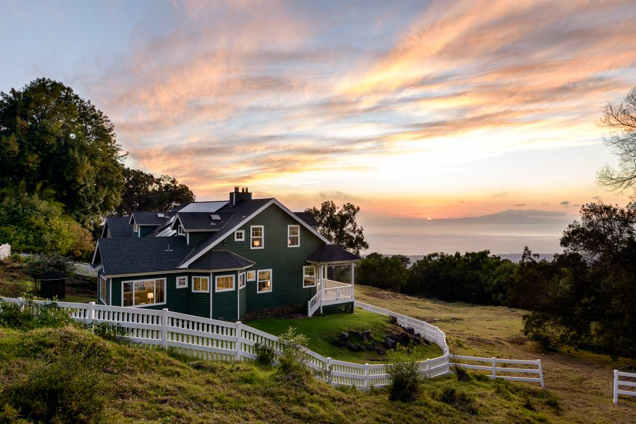 an aerial view of house with a garden