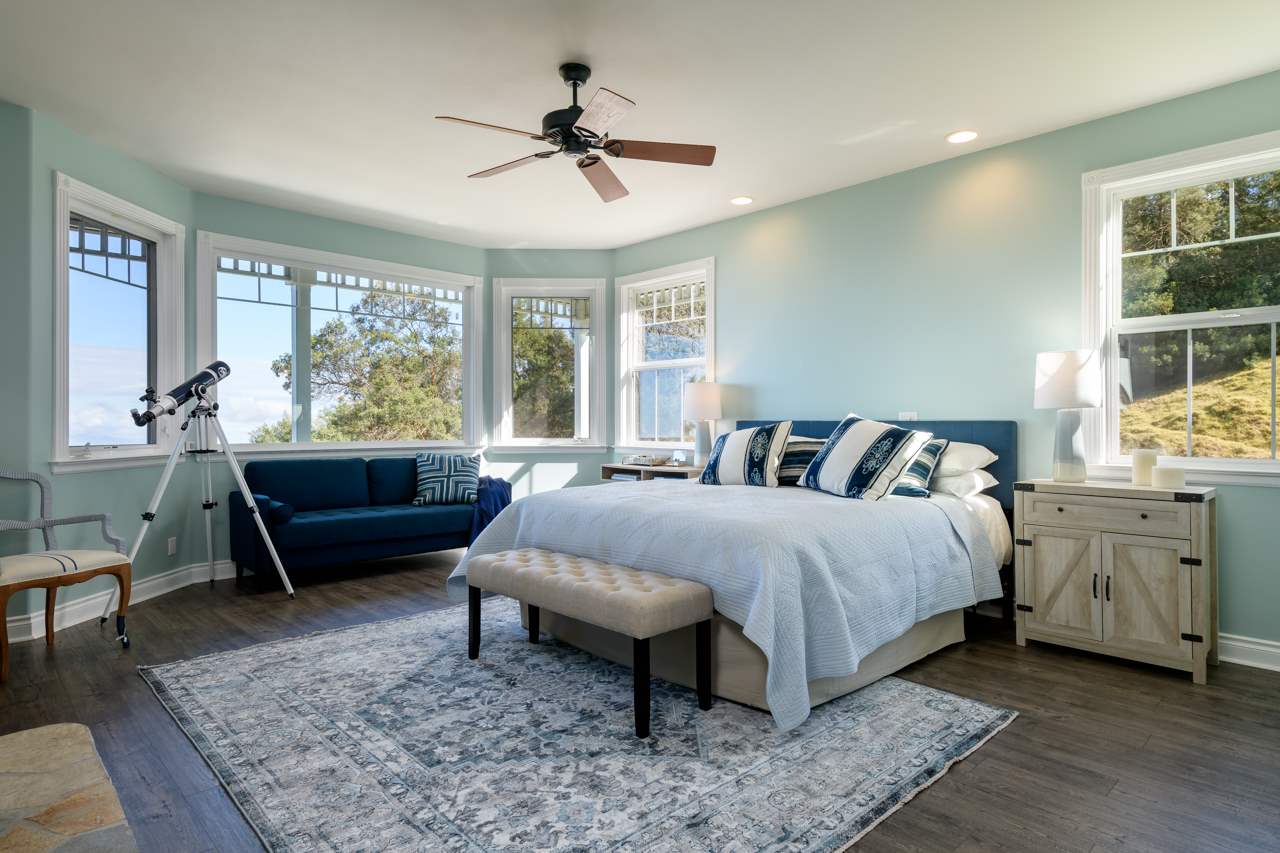 1511 Polipoli Road, Unit A & B Kula, HI 96790 - Photo 12 of 30 a spacious bedroom with a bed a couch and large window