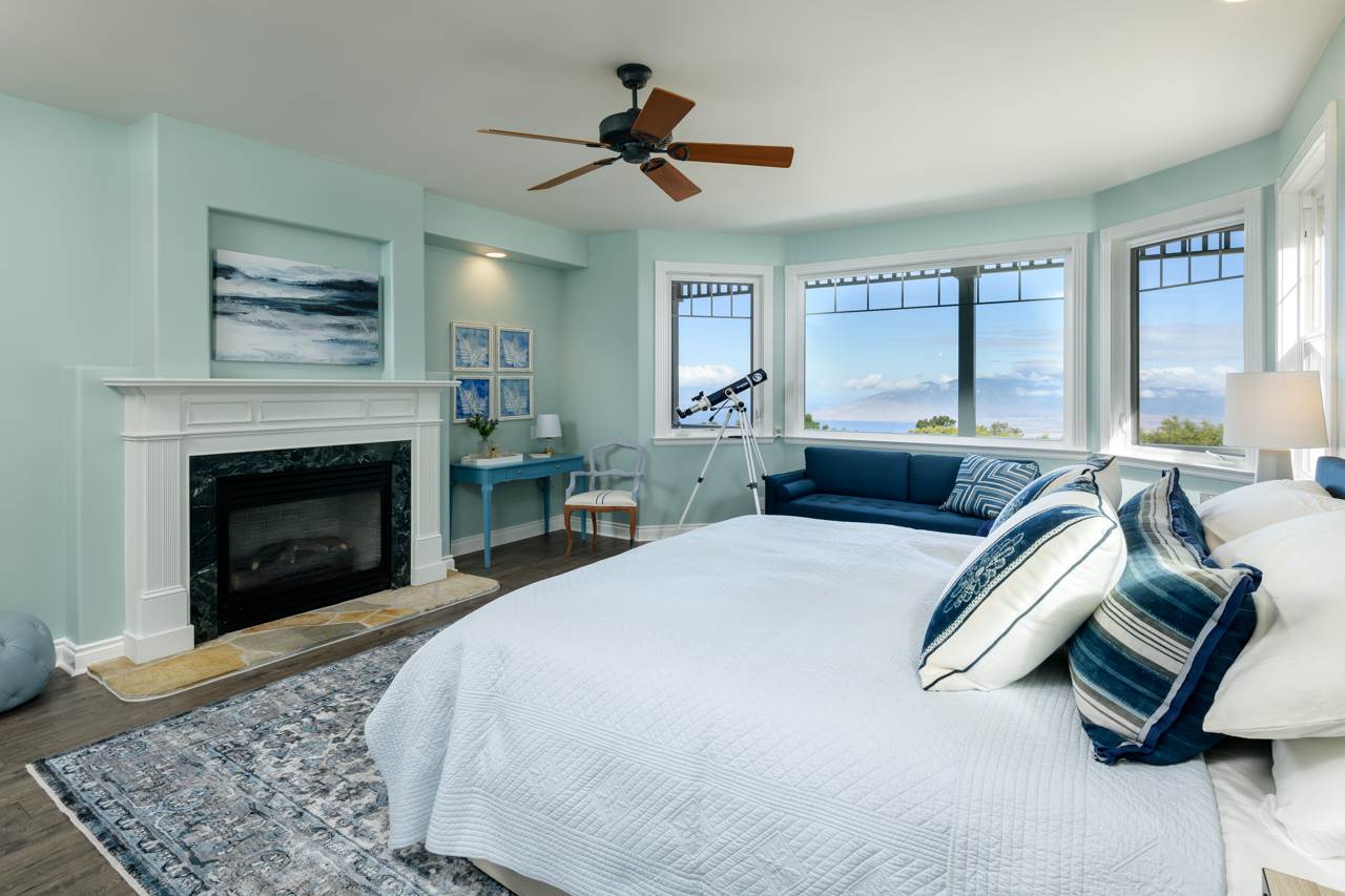 1511 Polipoli Road, Unit A & B Kula, HI 96790 - Photo 13 of 30 a spacious bedroom with a large bed a fireplace and windows