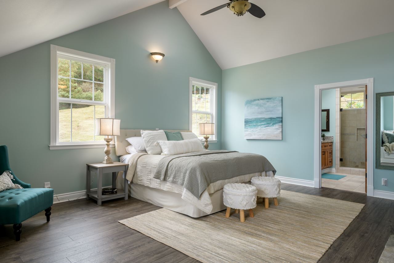 1511 Polipoli Road, Unit A & B Kula, HI 96790 - Photo 20 of 30 a bedroom with a bed and wooden floor