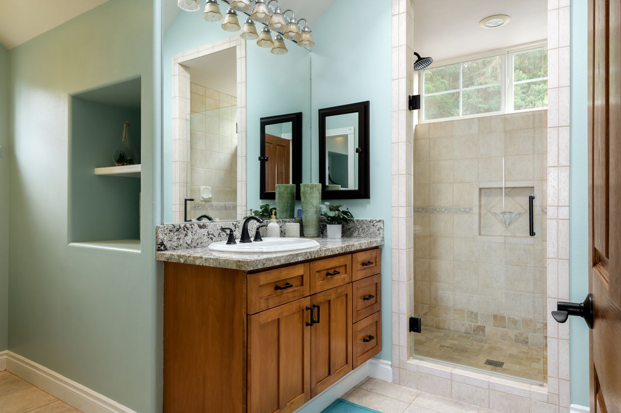 1511 Polipoli Road, Unit A & B Kula, HI 96790 - Photo 21 of 30 a bathroom with a granite countertop sink a mirror and a shower