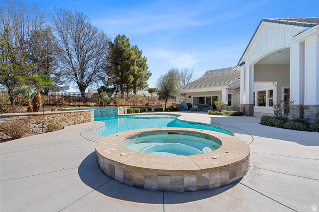 2917 Old Farm Road Washington, UT 84780 - Photo 49 of 105 View of pool featuring patio surround and an in-ground hot tub