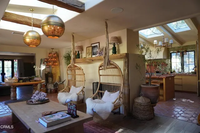 a room with furniture and view of kitchen