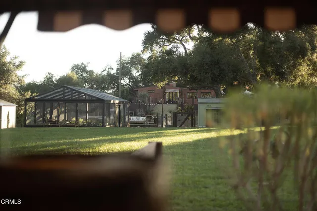 a view of a house with a tree in the background