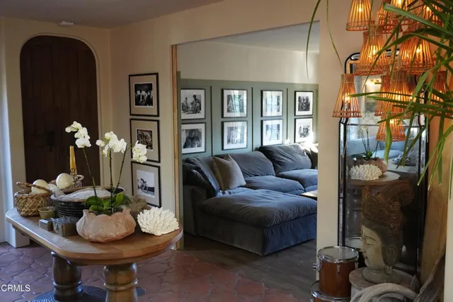 a living room with furniture and a potted plant