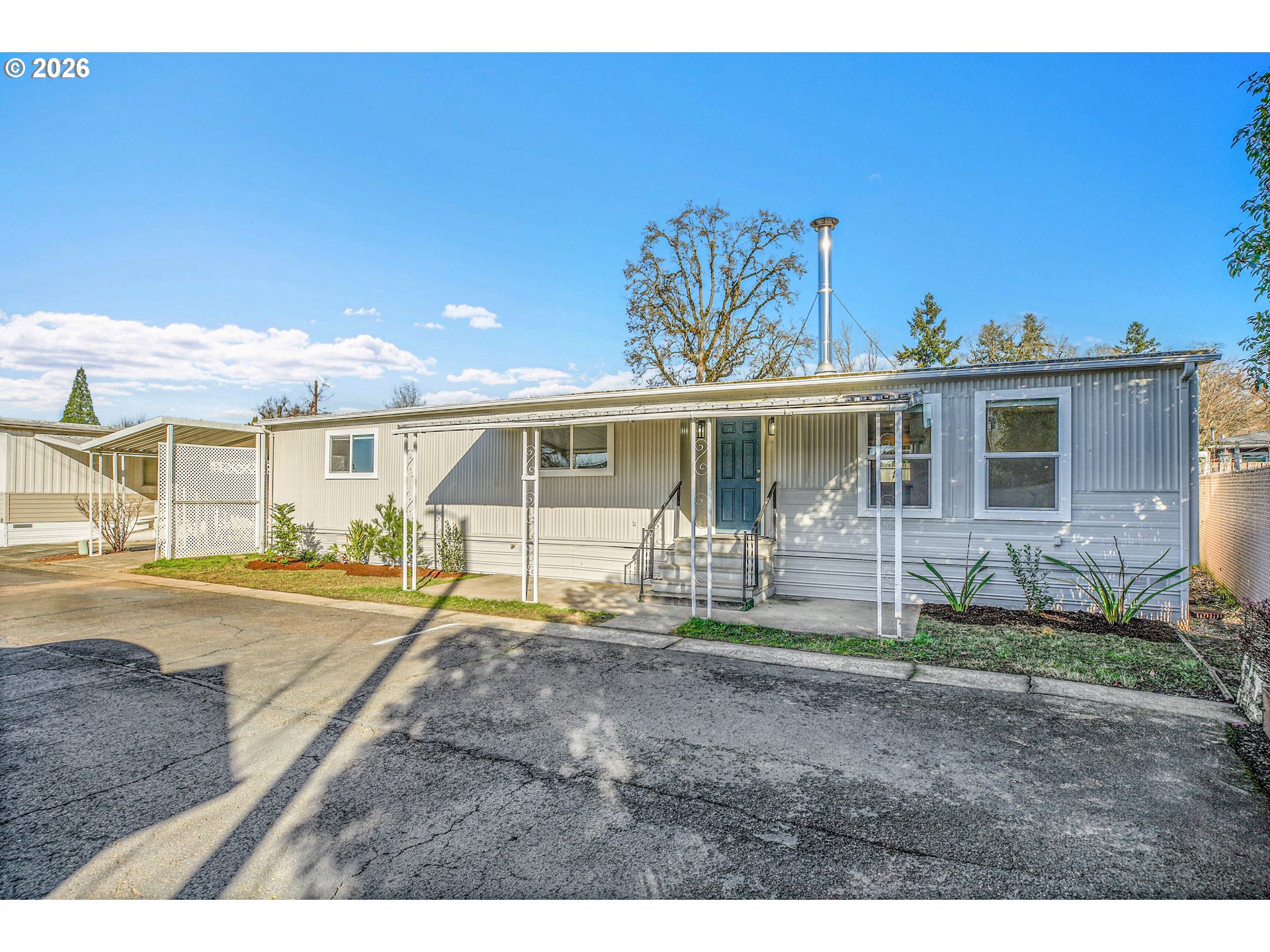 4400 Southeast Roethe Road, Unit 51 Milwaukie, OR 97267 - Photo 1 of 48 a front view of a house with a yard