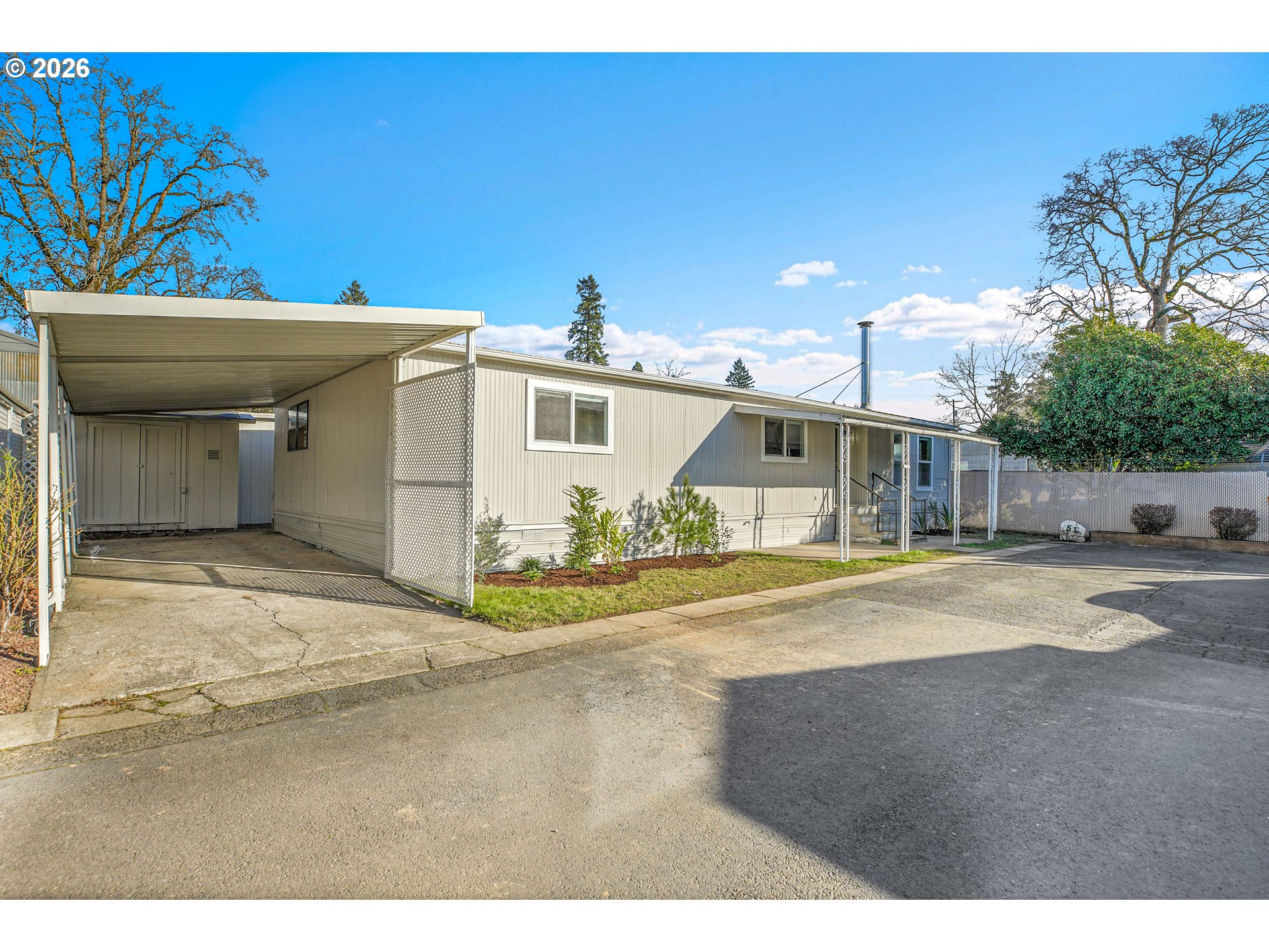 4400 Southeast Roethe Road, Unit 51 Milwaukie, OR 97267 - Photo 2 of 48 a front view of a house with a yard