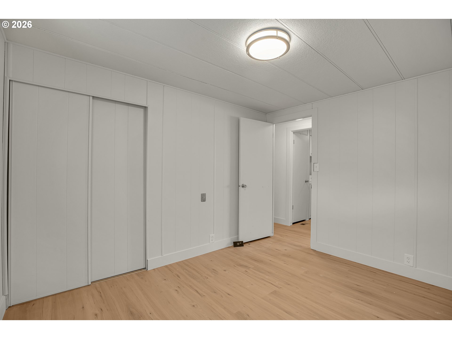 4400 Southeast Roethe Road, Unit 51 Milwaukie, OR 97267 - Photo 24 of 48 a view of an empty room with wooden floor