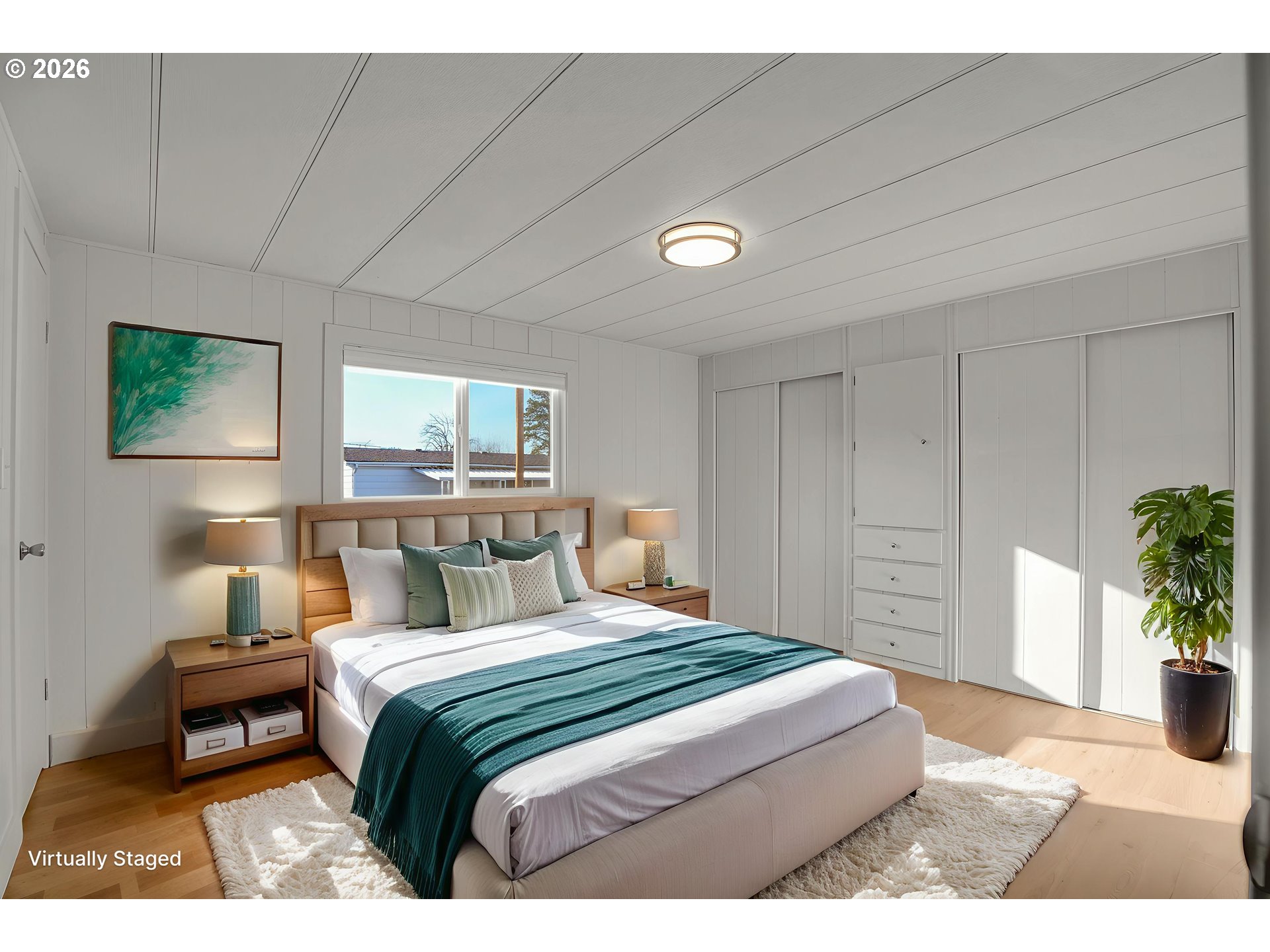 4400 Southeast Roethe Road, Unit 51 Milwaukie, OR 97267 - Photo 27 of 48 a bedroom with a large bed a potted plant and a dresser