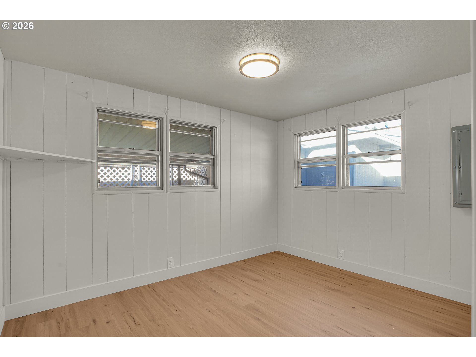 4400 Southeast Roethe Road, Unit 51 Milwaukie, OR 97267 - Photo 32 of 48 an empty room with wooden floor and windows