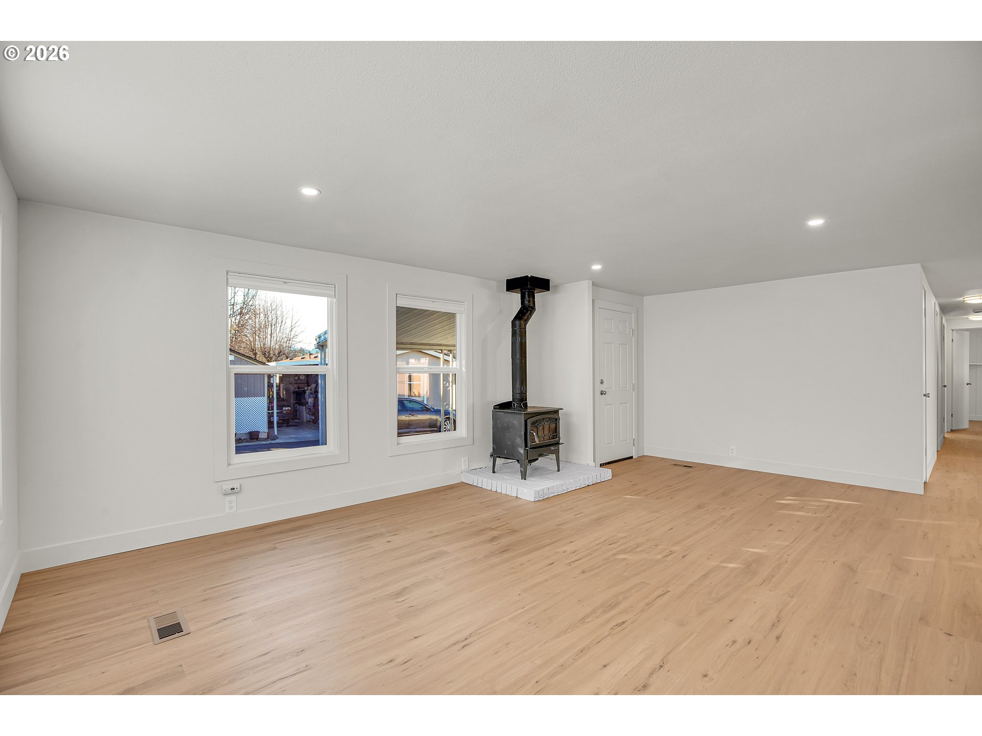 4400 Southeast Roethe Road, Unit 51 Milwaukie, OR 97267 - Photo 8 of 48 a view of an empty room with wooden floor and a window