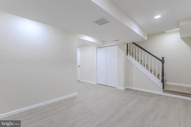 a view of hallway with stairs and a closet