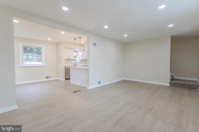 a view of workspace with wooden floor and windows