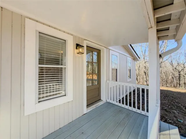 a view of an entryway with wooden floor