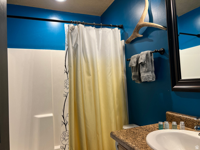 890 East Hatchery Road Bicknell, UT 84715 - Photo 10 of 48 Bathroom featuring vanity and shower / bathtub combination with curtain