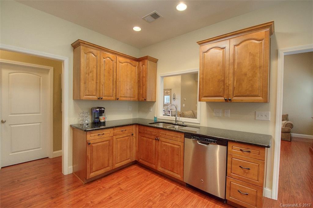 8685 Unity Church Road Denver, NC 28037 - Photo 14 of 24 a kitchen with stainless steel appliances granite countertop a sink and cabinets with wooden floors