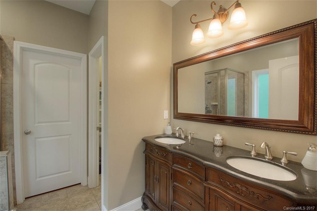8685 Unity Church Road Denver, NC 28037 - Photo 22 of 24 a bathroom with double vanity sinks and a mirror
