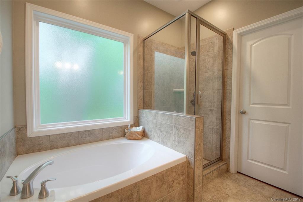 8685 Unity Church Road Denver, NC 28037 - Photo 23 of 24 a bathroom with a tub and a shower
