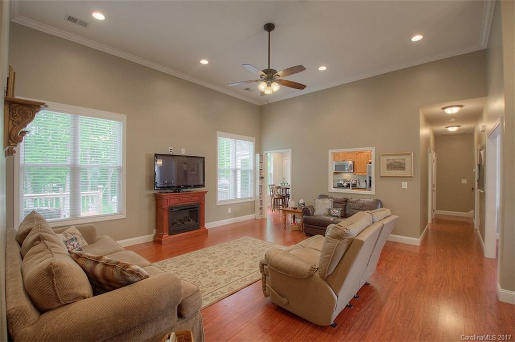 8685 Unity Church Road Denver, NC 28037 - Photo 7 of 24 a living room with furniture a fireplace and a flat screen tv