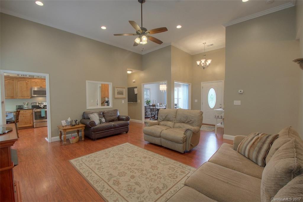 8685 Unity Church Road Denver, NC 28037 - Photo 9 of 24 a living room with furniture and a chandelier