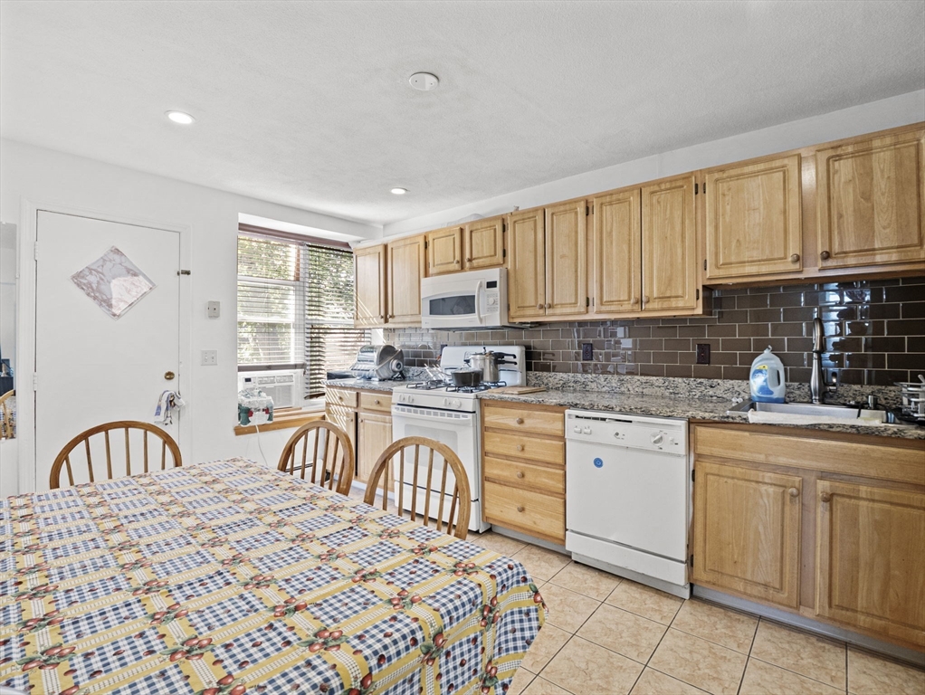 95 Florida Street, Unit 2 Boston, MA 02124 - Photo 9 of 29 a kitchen with stainless steel appliances granite countertop a stove a sink and a refrigerator