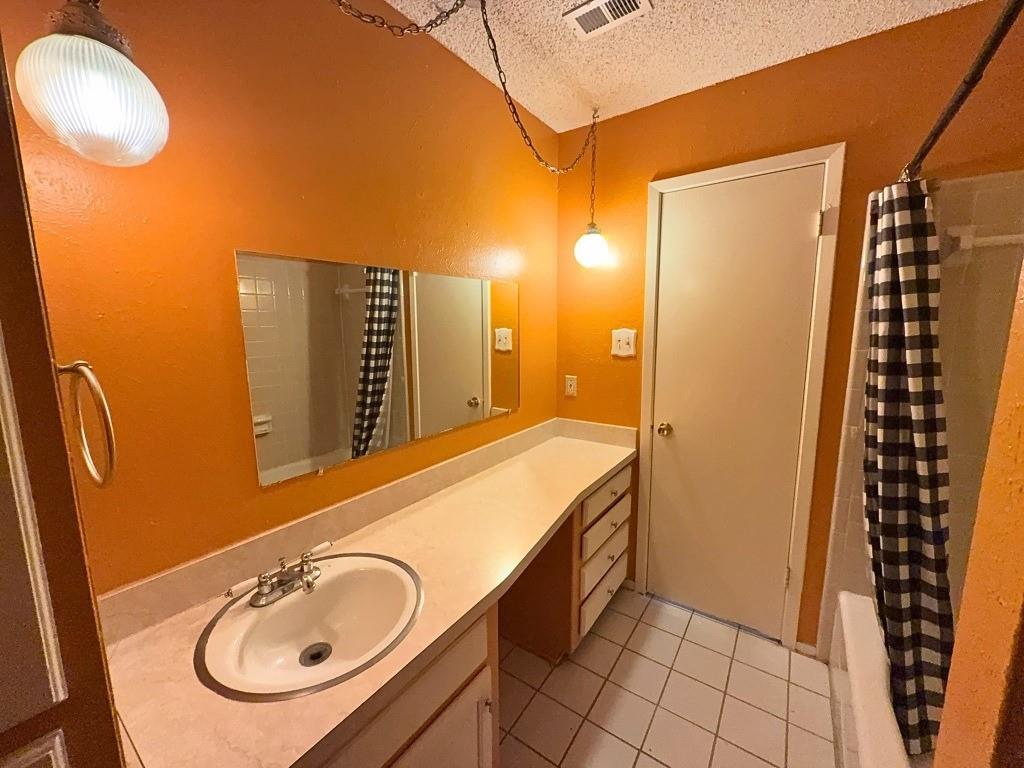 1613 Edgehill Road Benbrook, TX 76126 - Photo 11 of 22 a bathroom with a sink and a mirror