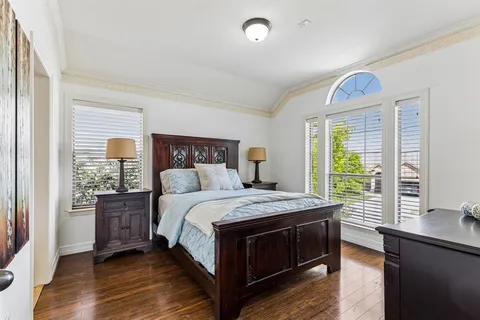 a bedroom with a large bed and a window